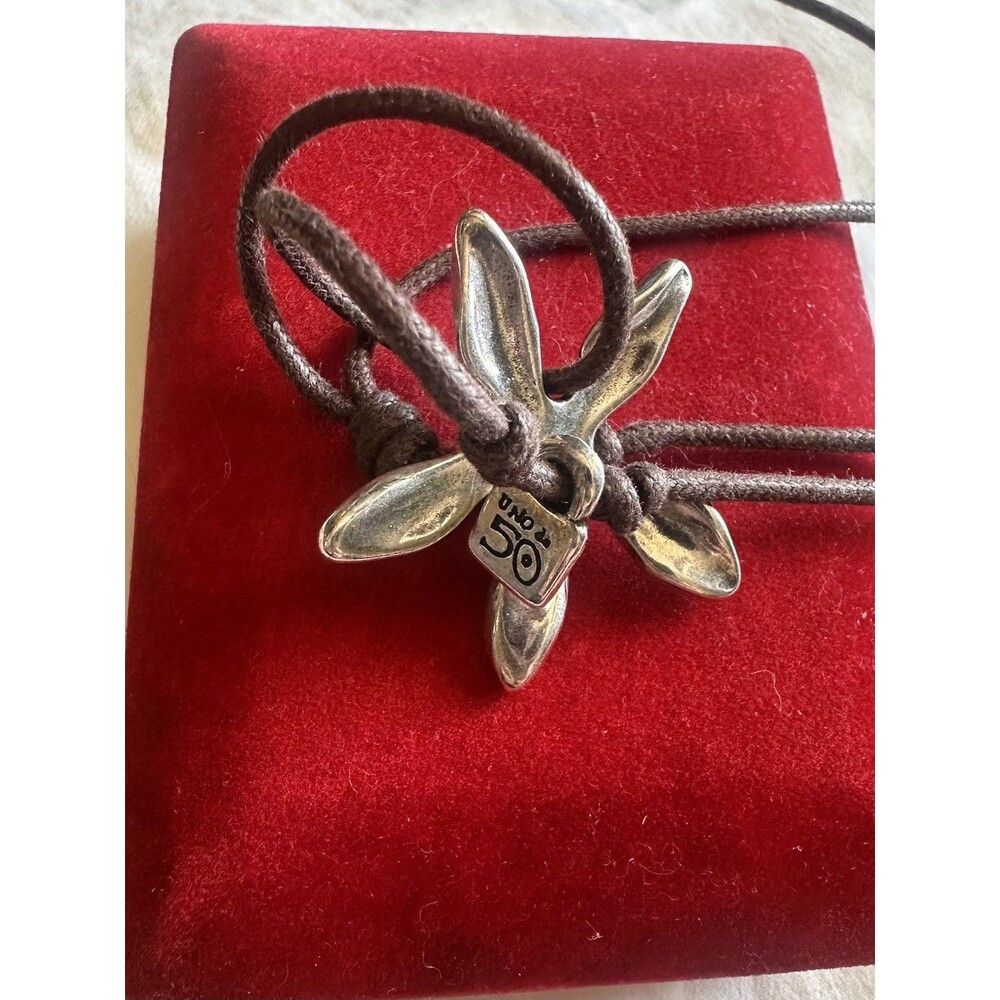 Uno De 50 flower pendant silver-plated adjustable brown cord with box.